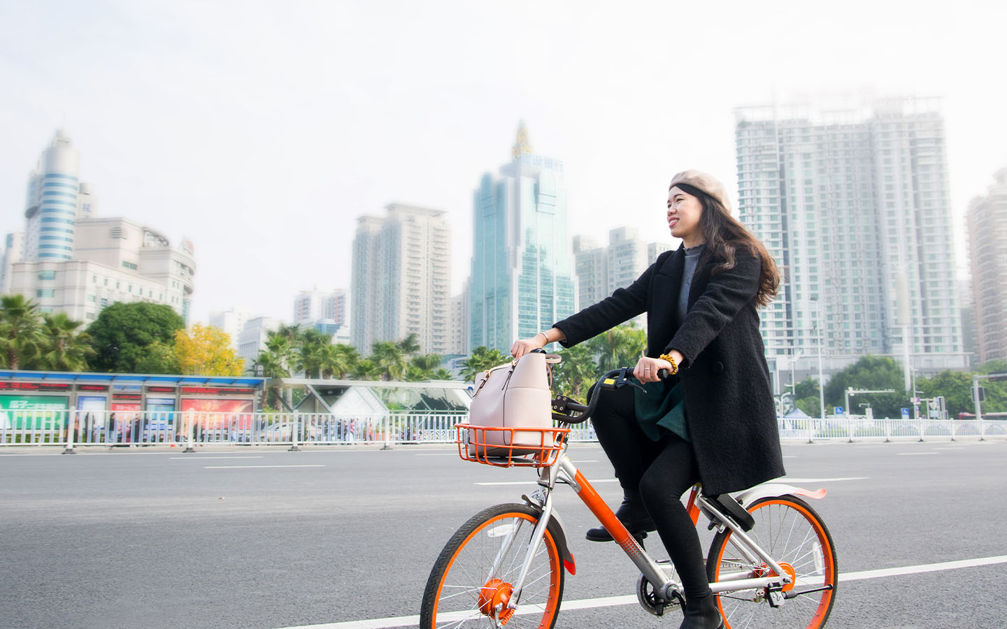 A rider on an orange Hellobike bicycle in a city street